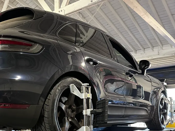 SUV on the alignment rack with alignment heads mounted, Top Speed Auto Center